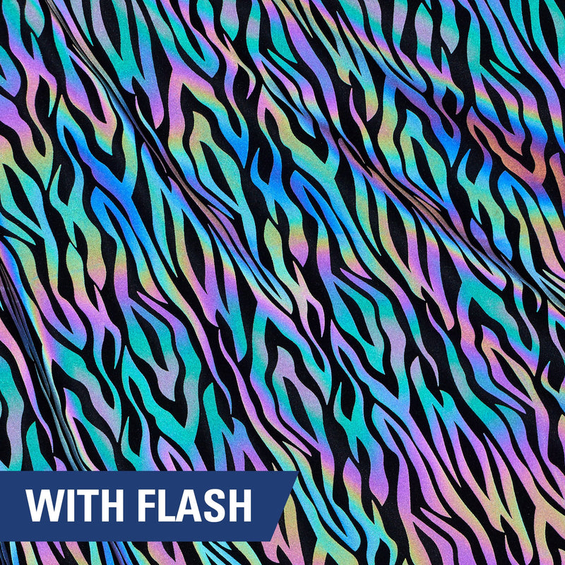 A rippled piece of Nocturnal Rainbow Reflective Spandex with a zebra stripe print under a camera flash.