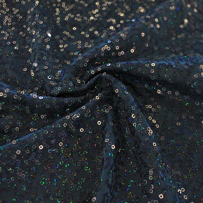 A swirled sample of zsa spa spandex sequin in the color deep sea titanium.