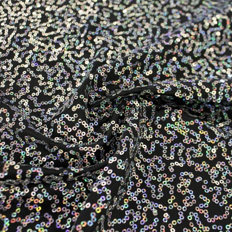 A swirled sample of zsa spa spandex sequin in the color black-silver.