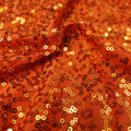 A flat sample of zsa zsa spandex sequin in the color orange.