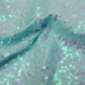 A swirled sample of zsa zsa pearl spandex sequin in the color pearl mint.