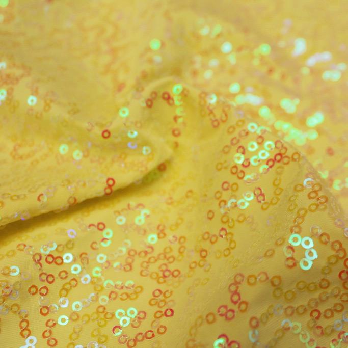 A swirled sample of zsa zsa pearl spandex sequin in the color pearl yellow.