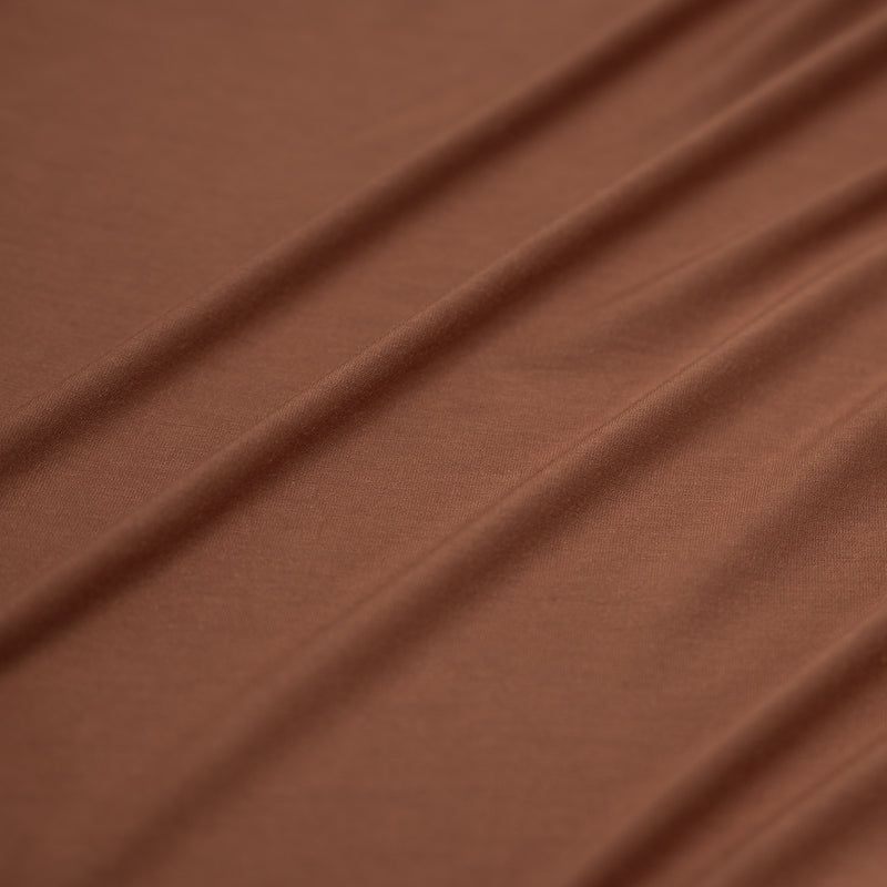 A sample of Bliss Micro Modal Spandex Jersey Fabric in the color Sweet Syrup