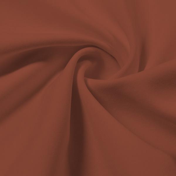 A swirled piece of Synergy Polyester Lycra in the color Pale Copper