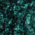A flat sample of Fame Stretch Mesh Sequin with black mesh and turquoise sequin.