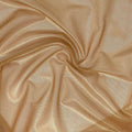 A swirled sample of ultra sheen metallic foiled power mesh with a nude mesh and gold foil available at Blue Moon Fabrics.