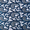 A flat sample of Milania foiled lace in the color royal blue.