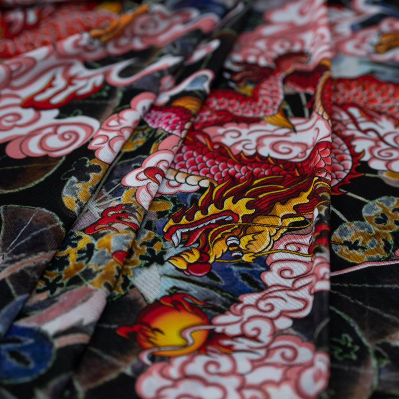 A folded sample of Red Dragon on Japanese Garden Tattoo Printed Power Mesh